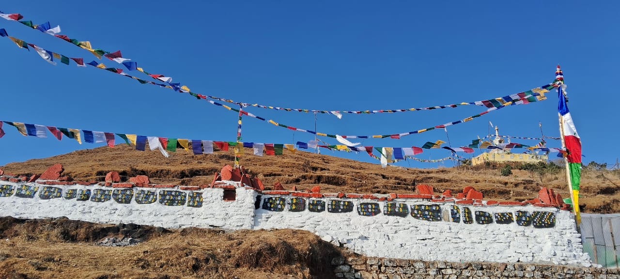 Prayer flags and mani stones on the ridge at Tumling