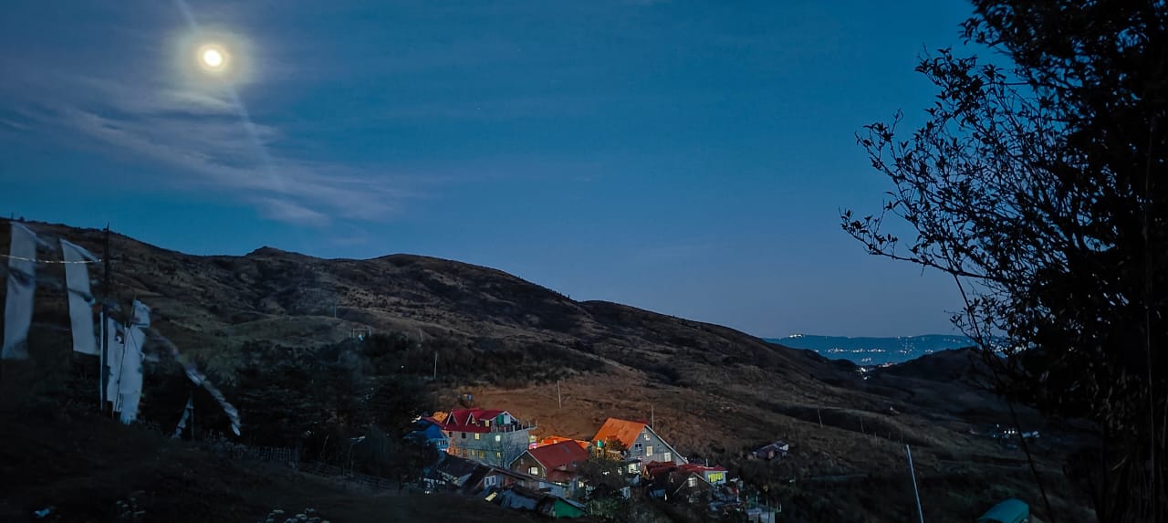 Sunset over the Himalayan ridge with prayer flags in foreground