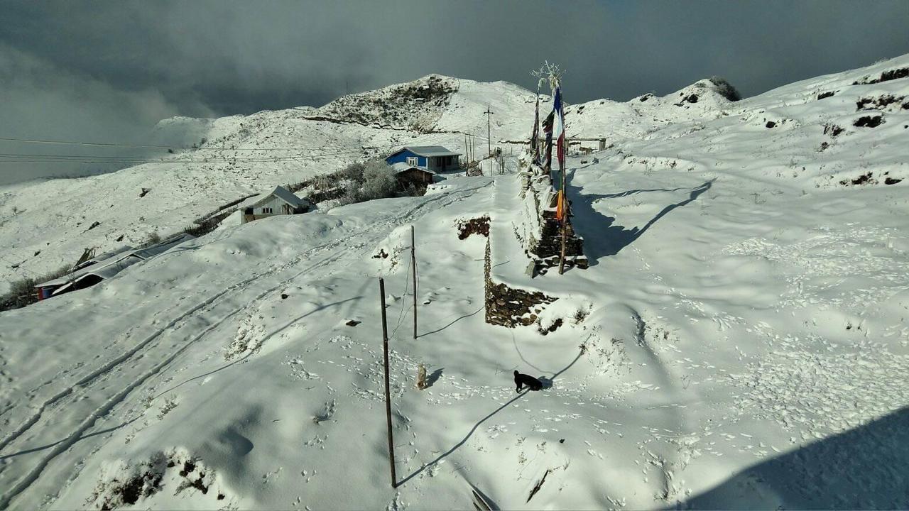 Deep snow and colourful prayer flags on the ridge