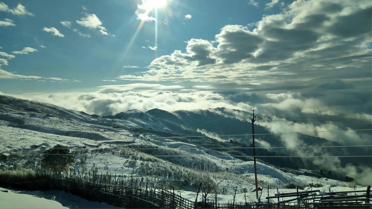 Winding mountain road in snow on a clear morning